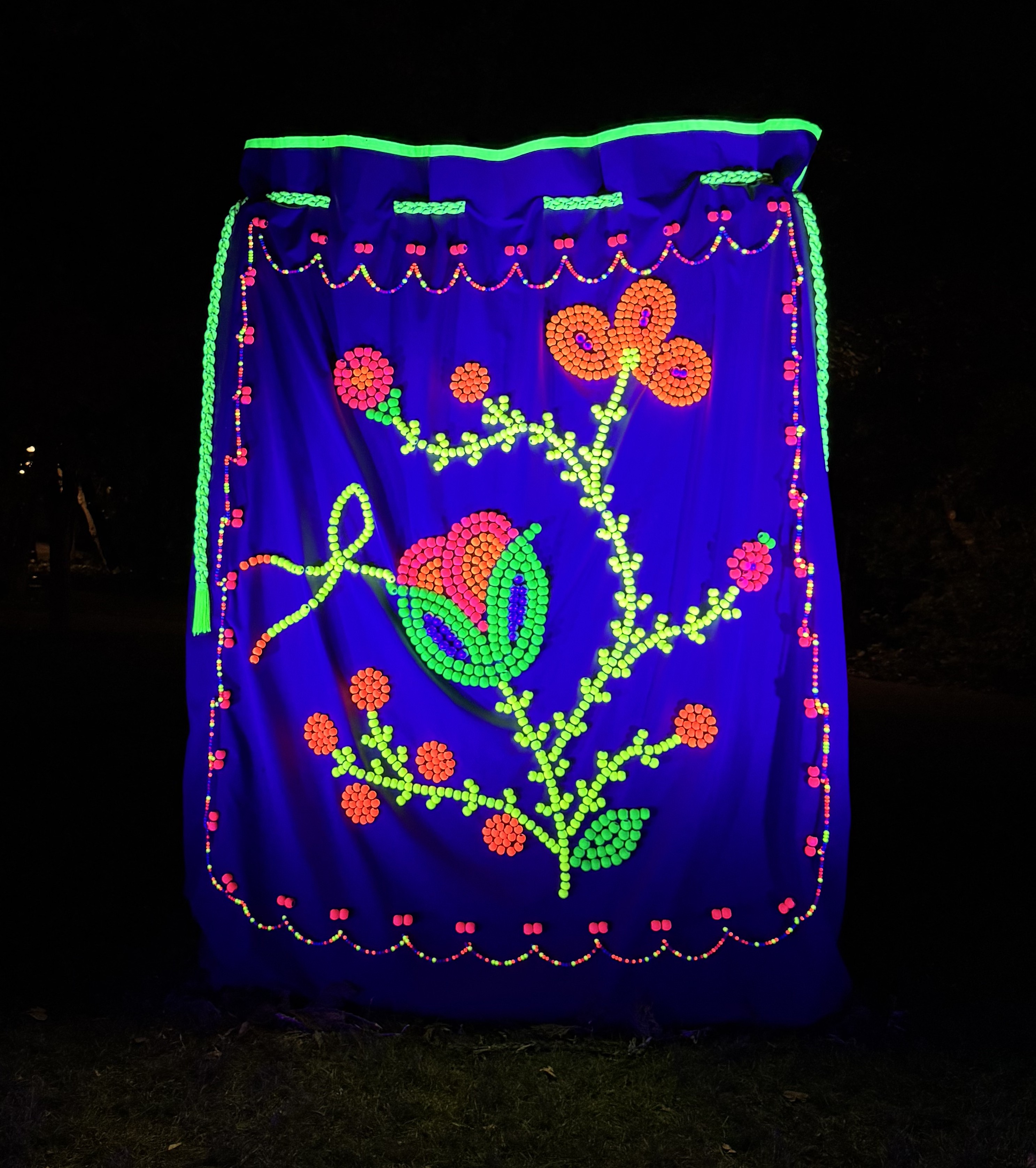 Image credit for film photograph(s): George Gibson  iPhone photo credits: Claire Johnston  Title of work: 'how do you use your medicine?' Date: 2025 Medium: Black canvas, neon spray painted wooden beads, acrylic beads, nylon thread, climbing rope, ribbon  Ownership: collection of the artist  Dimensions: 6 ft x 8 ft